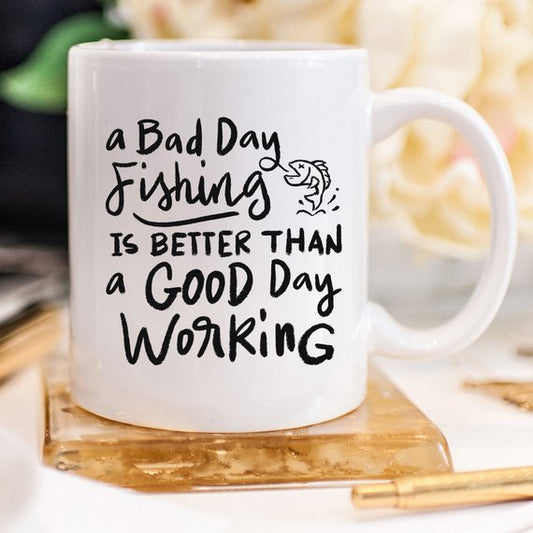 11oz ceramic coffee mug with “A Bad Day Fishing Is Better Than a Good Day Working” quote; perfect gift for fishermen and women who love humor and the outdoors.