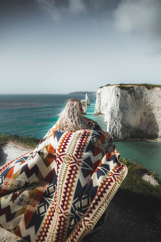 Awa Blanket in Vibrant Autumn colors with reversible design handcrafted in Ecuador from recycled hypoallergenic materials perfect for home decor and camping