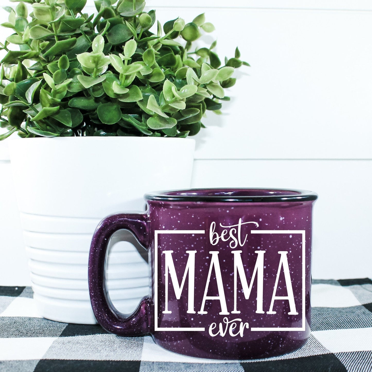 15 oz ceramic campfire mug with 'Best Mama Ever' design in durable vinyl print. Microwave safe, sturdy build, ideal for coffee, tea, or cocoa. Hand wash recommended.