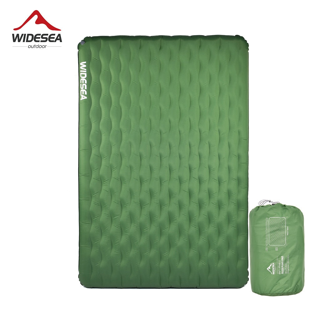 Inflatable green camping mattress with a texture surface, displayed next to its green carrying bag.