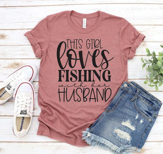 “This Girl Loves Fishing With Her Husband” women’s t-shirt, made from soft Bella+Canvas cotton with a flattering unisex fit—perfect for fishing wives and outdoor adventures.